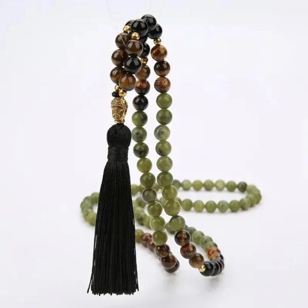 Green, brown, and black beaded necklace with tassel.