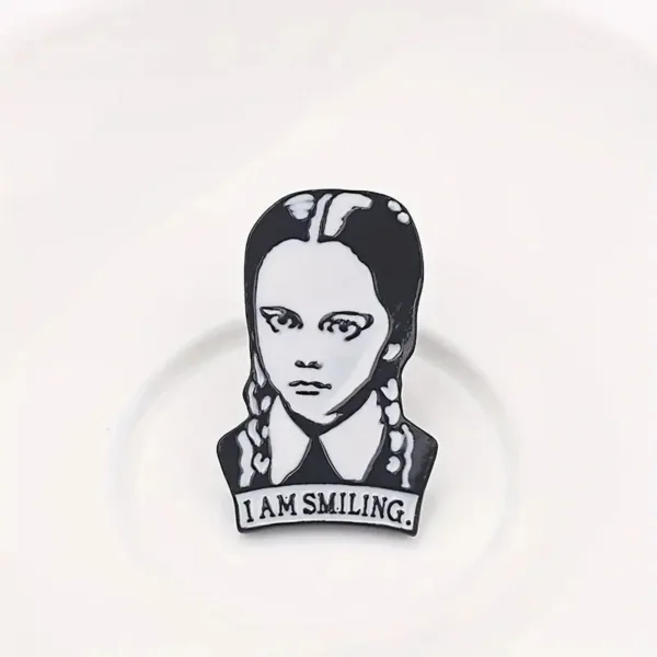 Black and white "I am smiling" pin.