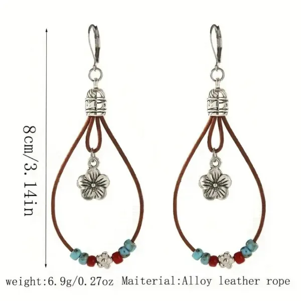 Silver flower dangle earrings with leather cord.