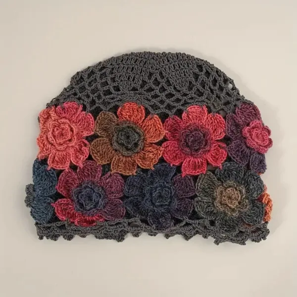 Crocheted floral hat with gray base.