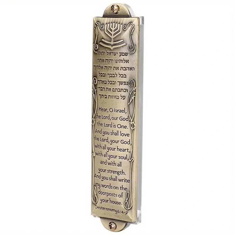 Gold mezuzah with Hebrew text and English translation.