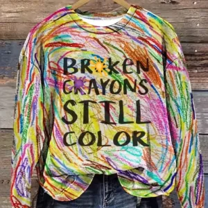 Colorful shirt with "Broken Crayons Still Color" text.