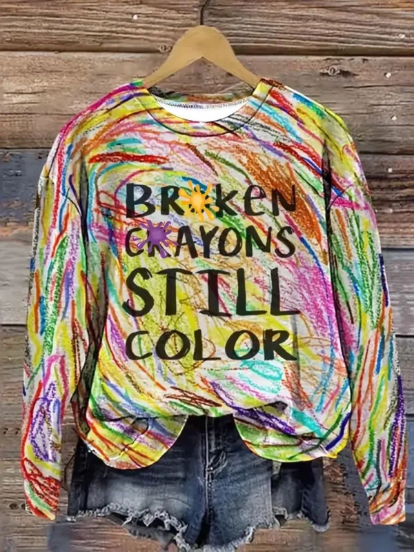 Colorful shirt with "Broken Crayons Still Color" text.