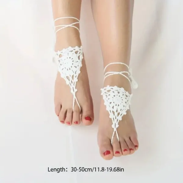 White crochet barefoot sandals on feet.