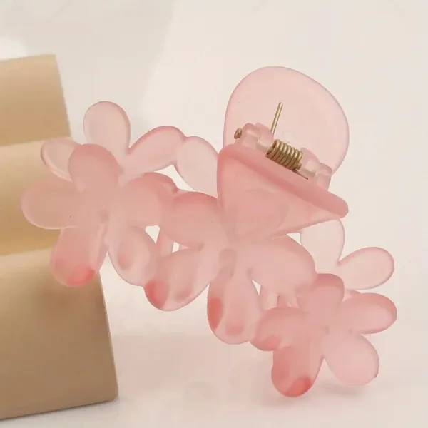 Pink flower shaped hair clip.