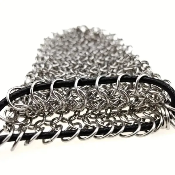 Silver chainmail oven mitt with black trim.