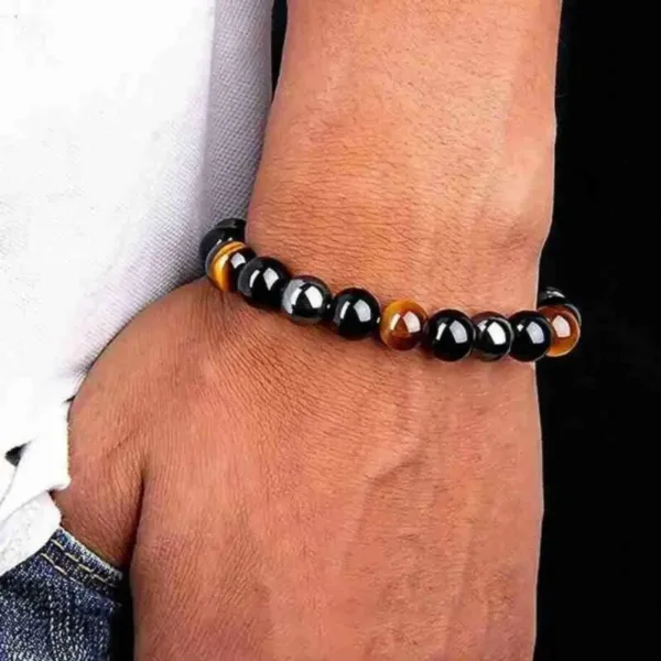 Black and tiger's eye beaded bracelet on wrist.