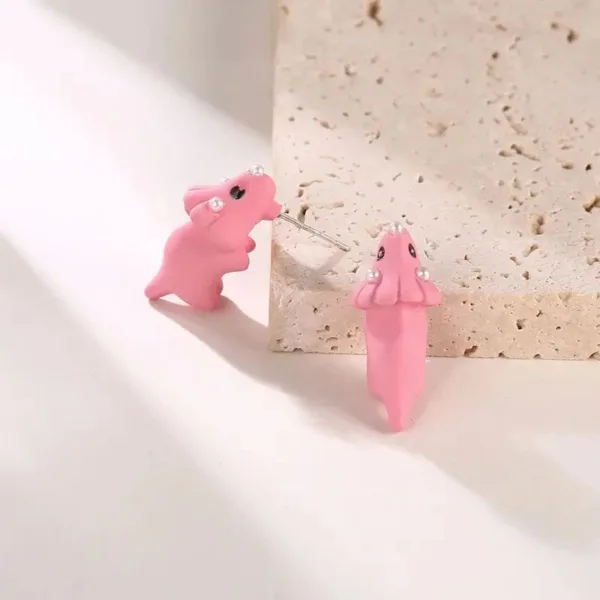 Pink dinosaur and octopus stud earrings.