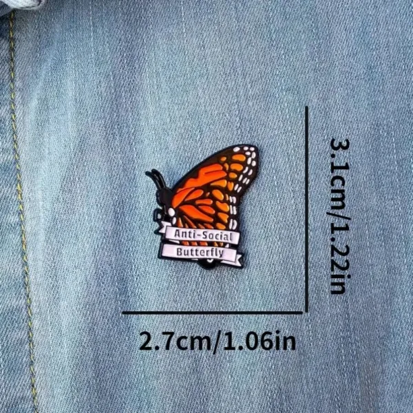 Anti-social butterfly enamel pin on denim.