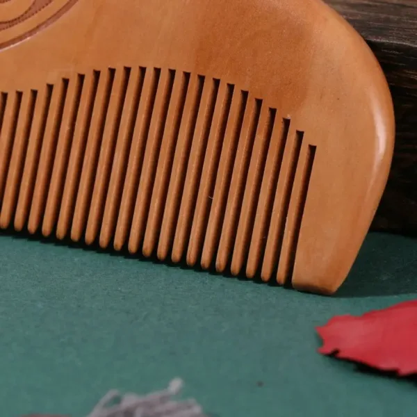 Wooden comb with fine teeth.