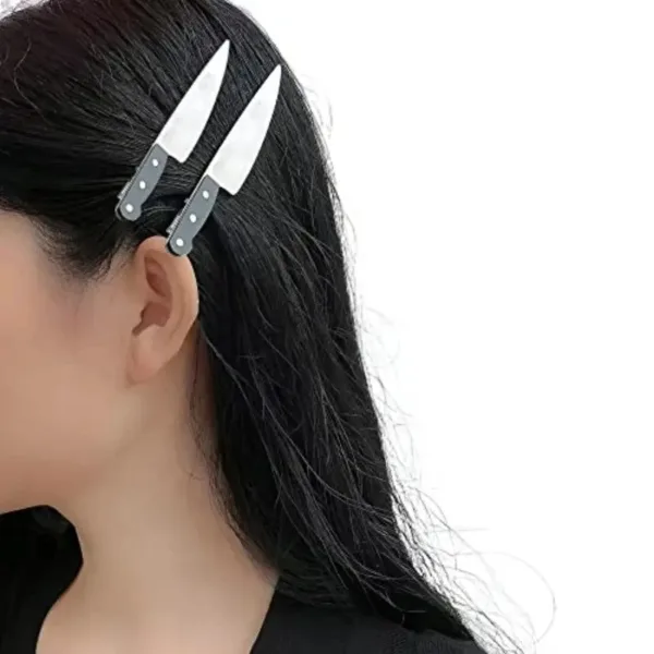 Woman with black hair wearing knife hair clips.