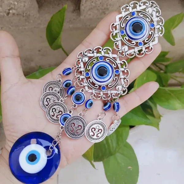 Silver evil eye charm with beads and coins.