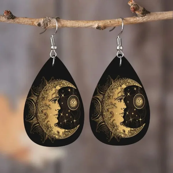 Black teardrop earrings with moon and sun design.