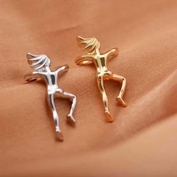 Two gold and silver figure earrings.