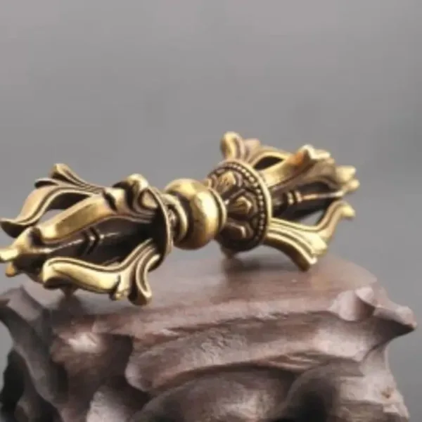 Ornate brass ritual vajra on a base.