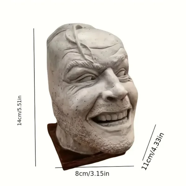 White plaster bust of a smiling man.