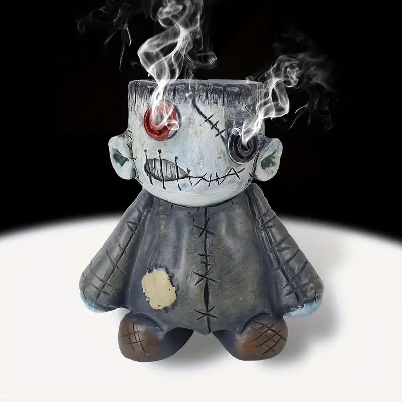 Stitched monster incense burner with smoke.