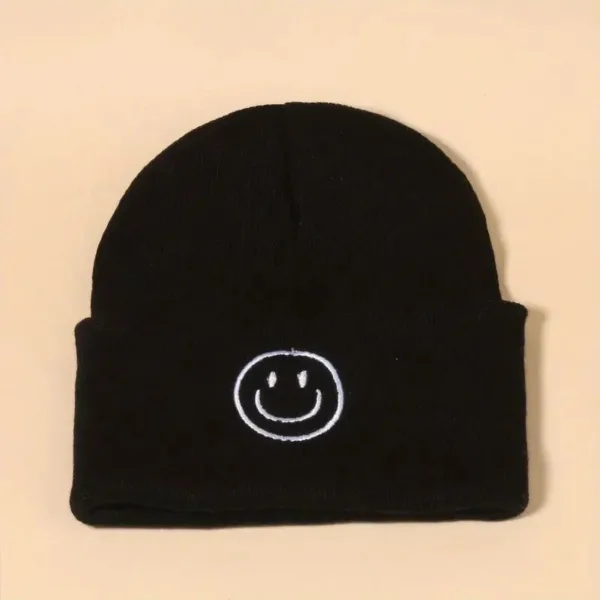 Black beanie with white smiley face.