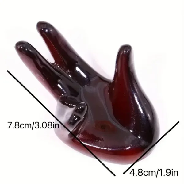 Brown hand-shaped ring holder stand.