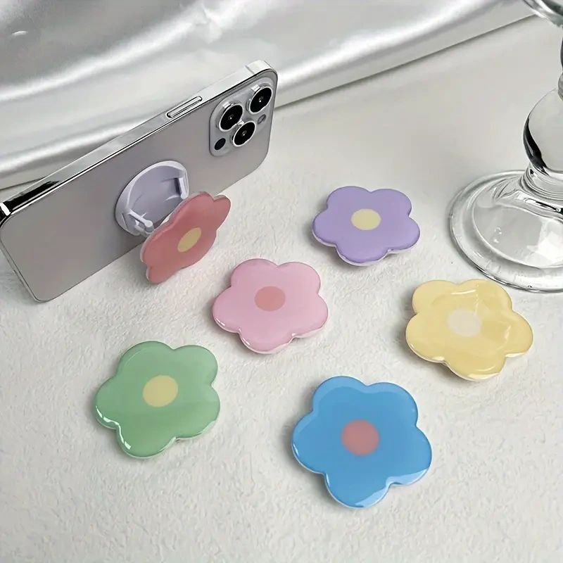 Colorful flower phone grips on white background.