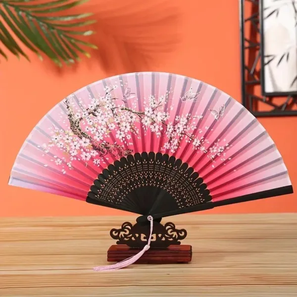 Pink and black folding fan with cherry blossoms.