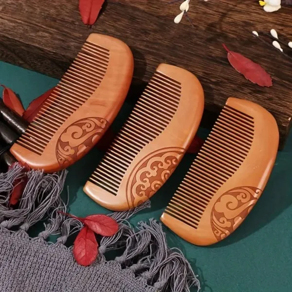 Three ornate wooden combs on a table.