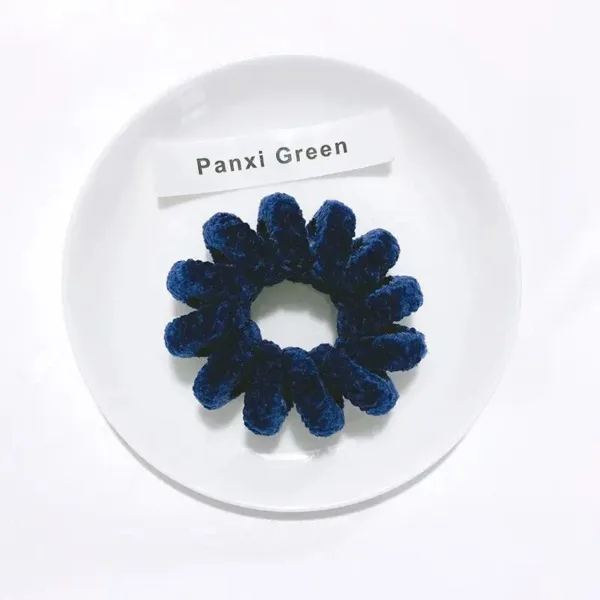 Blue velvet scrunchie on white plate.