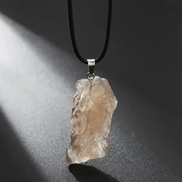 Raw crystal pendant on black cord.