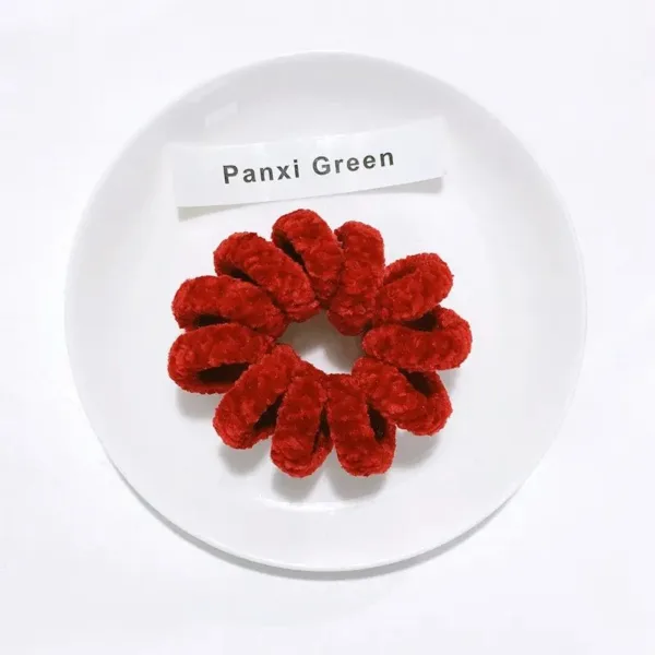 Red velvet scrunchie on white plate.