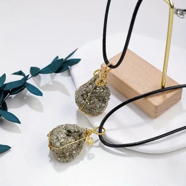 Two gold-wrapped pyrite stone pendants.