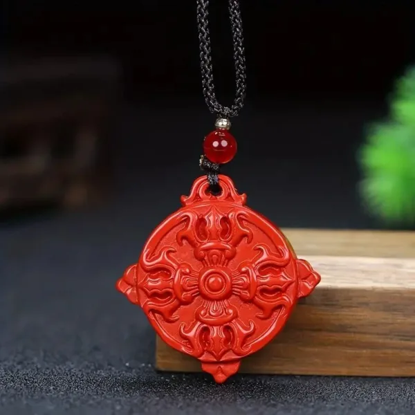 Red carved pendant on a black cord necklace.