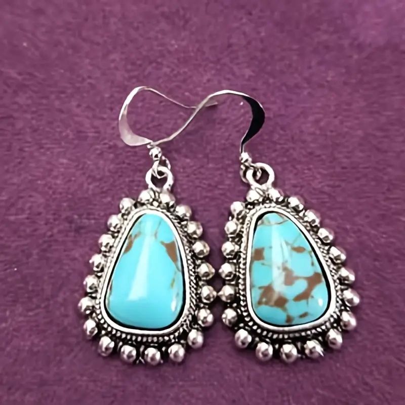 Silver earrings with turquoise stones.