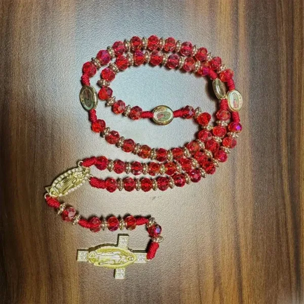 Red rosary with gold accents and cross.