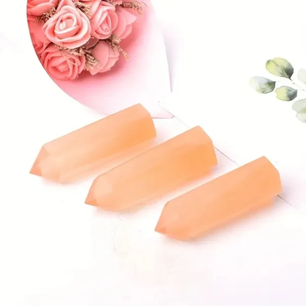 Three orange crystal points on white background.