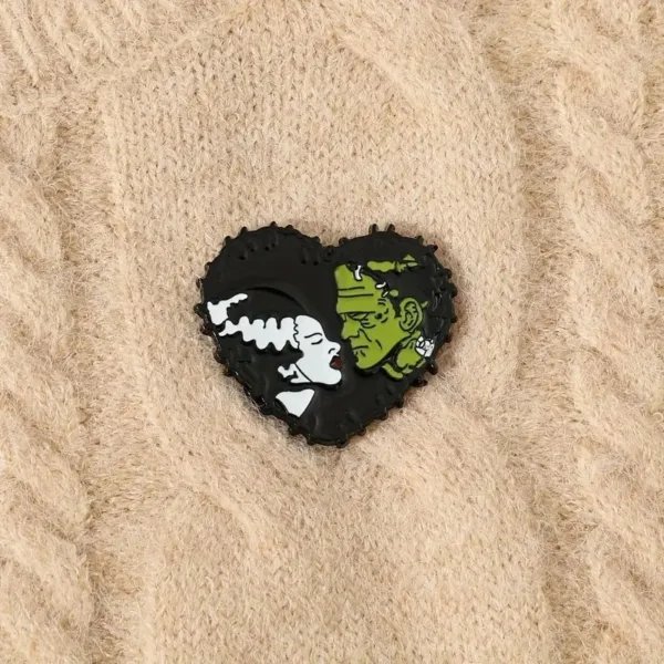 Black and white heart-shaped monster pin.