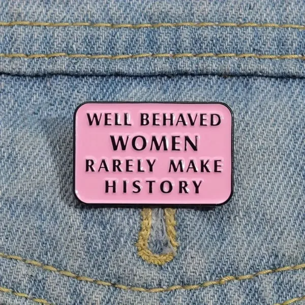 Pink enamel pin with feminist quote.