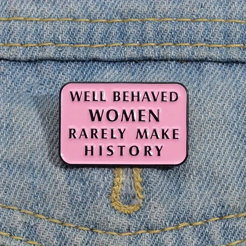 Pink enamel pin with feminist quote.