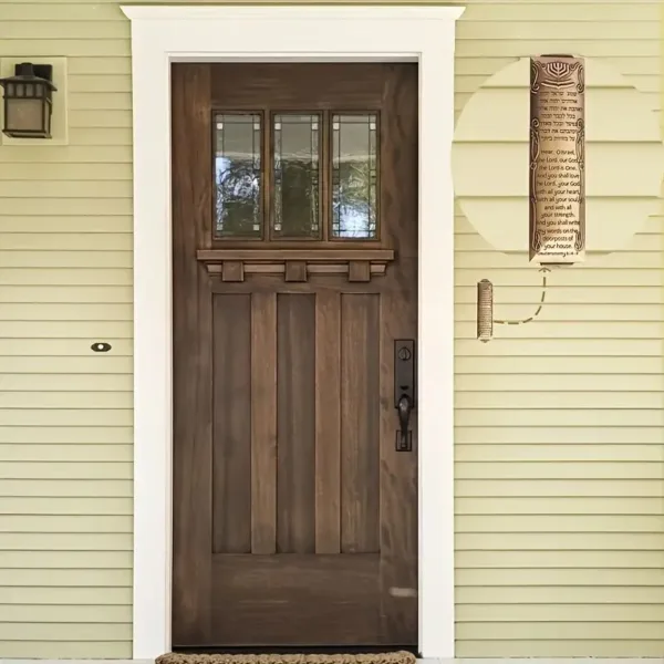 Wooden door with mezuzah on frame.