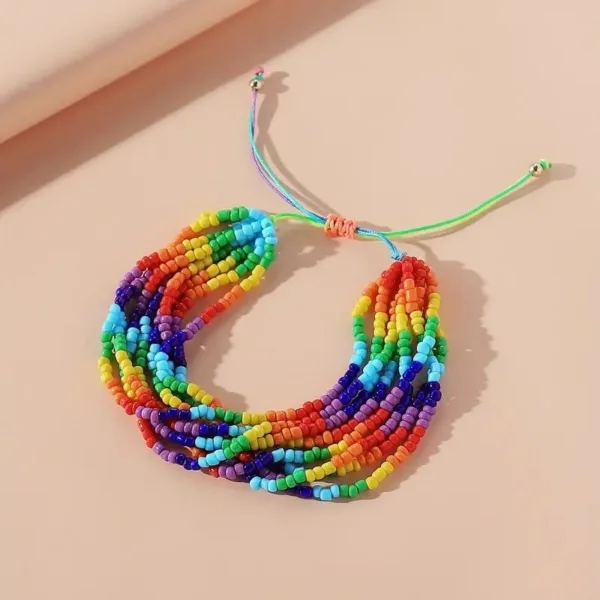 Rainbow beaded friendship bracelet with string ties.