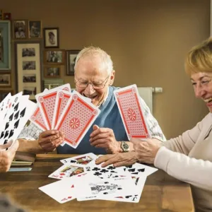 Two seniors playing cards together.