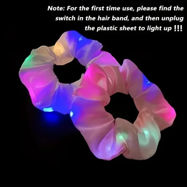 Two pink light up hair scrunchies.