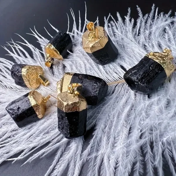 Black tourmaline pendants with gold accents.