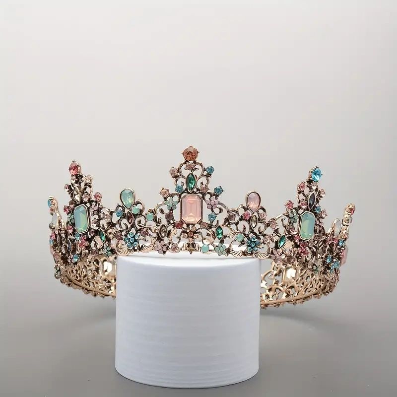 Gold jeweled crown with pink stones.