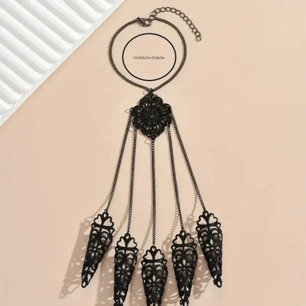 Black filigree bracelet with dangling charms.