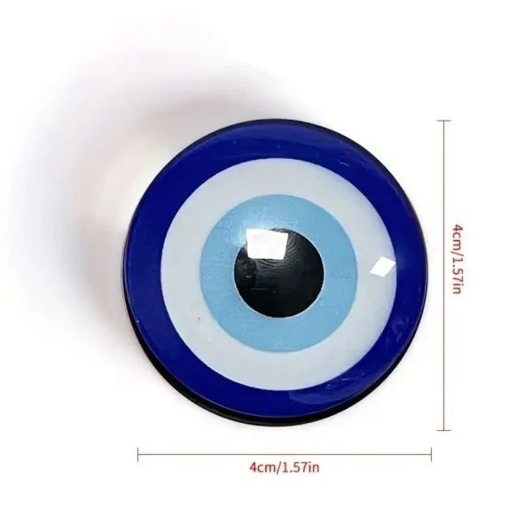 Blue evil eye charm with white and black center.