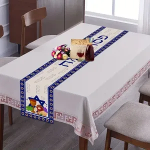 White tablecloth with blue and gold Passover runner.