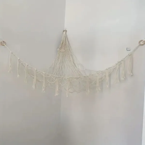 White macrame hammock hanging in corner.