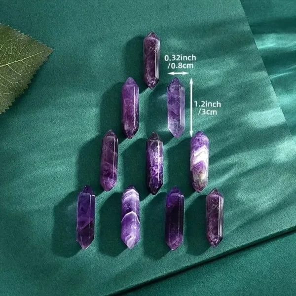 Nine purple amethyst crystal wands on green background.