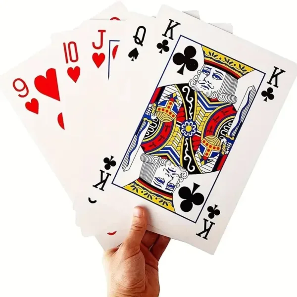 Hand holding playing cards, including King of Clubs.