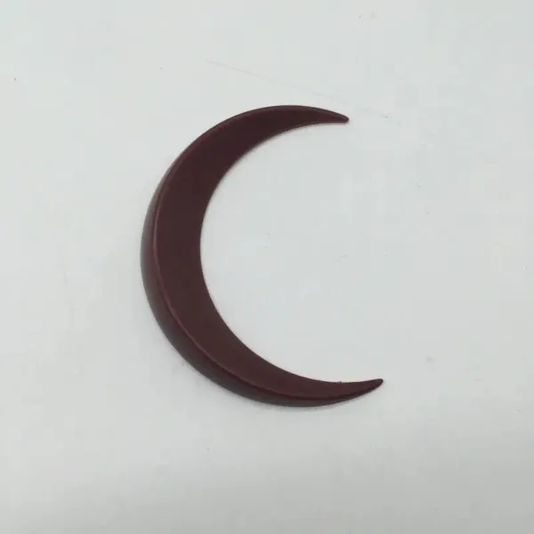 Red plastic crescent moon shape.